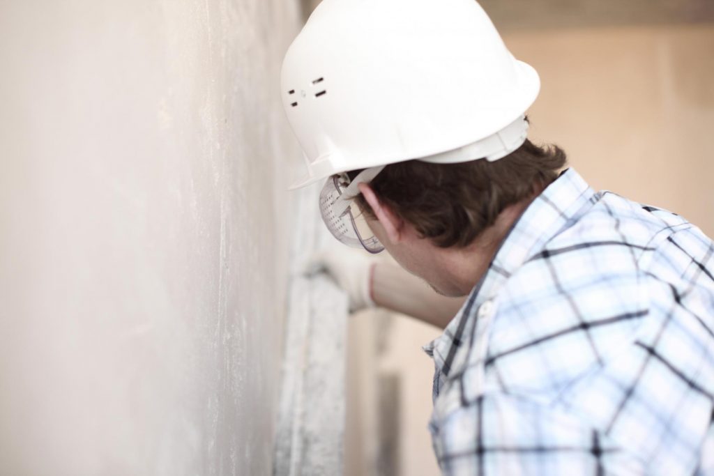 man measures the wall